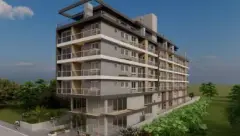 Fachada frontal no formato retrato com 7 andares, varandas e árvores ao redor — Maxxi IU em Jurerê, Florianópolis