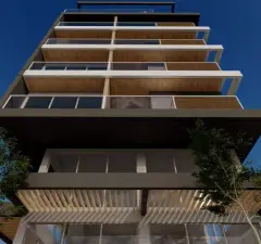 Detalhe da fachada frontal vista de baixo com 7 andares, revestimento de madeira e ripado no térreo — Maxxi IU em Jurerê, Florianópolis