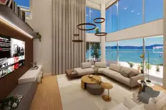 Sala de estar duplex com sofá curvo bege, lustre de anéis e vista panorâmica para o mar, ângulo alternativo — Maxxi View em Jurerê, Florianópolis