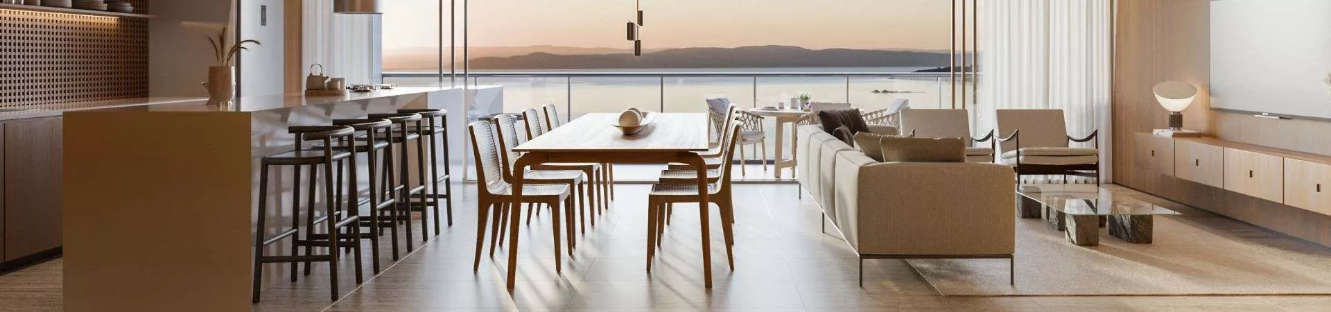 Sala de jantar e estar open plan com mesa de madeira, sofá bege e vista panorâmica para o pôr do sol sobre o mar — Meraki Sunset em João Paulo, Florianópolis