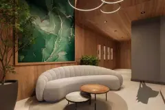Hall de entrada com sofá curvo branco, mesa redonda, quadro verde grande e luminária de anéis circulares — Mirá Apartments em Centro, Florianópolis