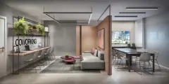 Coworking com bancada de madeira, cadeiras altas, sofá cinza, mesa de reuniões e TV — Miragio en Cacupé, Florianópolis