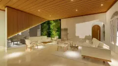 Hall social com sofás brancos, jardim vertical iluminado, teto ripado e elevador — Mirante dos Corais em Coqueiros, Florianópolis