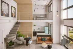 Interior do loft duplex com escada de concreto, mezanino com cama, cozinha e sofá caramelo — Mobby Campeche en Campeche, Florianópolis