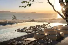 rooftop piscina entardecer luz dourada espreguiçadeiras sofás vista mar morros — Natus em Ponta das Canas, Florianópolis