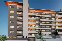 fachada entardecer dois volumes topo laranja varandas iluminadas — Neo Continente em Estreito, Florianópolis