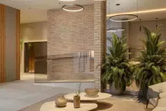 lobby hall ângulo frontal coluna tijolo palmeiras mesa café vasos — Neo Continente em Estreito, Florianópolis