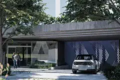 garagem subterrânea carro elétrico branco pessoas portão fundo azul chevrons fachada — Next Trindade em Trindade, Florianópolis