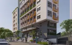 fachada render ângulo lateral torre 10 andares bege varandas verdes amarelas painel teal rua árvores carros dia — Parkside Itacorubi em Itacorubi, Florianópolis