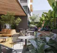 área de convivência coberta render ângulo alternativo mesas cadeiras banco circular jardim tropical edifício fundo — Parkside Itacorubi em Itacorubi, Florianópolis