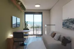 studio loft real sofá cinza mesa redonda janela sacada corrediça vista morro verde plantas pampas dia — Parkside Itacorubi em Itacorubi, Florianópolis
