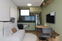 studio loft integrado real cozinha armários verdes geladeira inox forno microondas mesa jantar redonda sofá sacada corrediça planta — Parkside Itacorubi em Itacorubi, Florianópolis