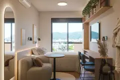 loft studio integrado noturno mesa trabalho cadeiras sofá cama casal vista morro TV prateleira madeira planta roupão — Parkside Itacorubi em Itacorubi, Florianópolis