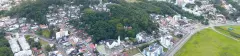 Vista aérea panorâmica do bairro da Carvoeira em Florianópolis, com cobertura verde, Igreja e rodovia SC-401 — Portal da Carvoeira em Carvoeira, Florianópolis