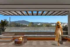Perspectiva da área de lazer do rooftop com fogão de lenha, bancos e vista para as montanhas — Puerto Canas em Canasvieiras, Florianópolis