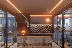 Perspectiva da varanda gourmet com churrasqueira, balcão com banquetas e iluminação indireta — Puerto Canas em Canasvieiras, Florianópolis