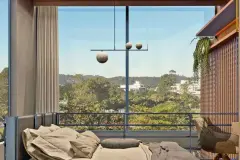 Perspectiva do dormitório com ampla janela de piso ao teto e vista para a vegetação e a cidade — Puerto Canas em Canasvieiras, Florianópolis