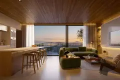 Perspectiva da sala de estar integrada à cozinha com sofá verde, bancada e vista para Jurerê ao entardecer — Puerto Madero em Jurerê, Florianópolis