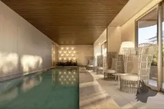 Perspectiva da piscina coberta com cadeiras em rattan e iluminação suave, ângulo alternativo — Puerto Madero em Jurerê, Florianópolis