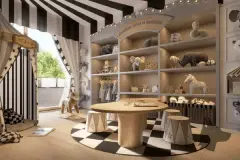 Perspectiva do espaço kids temático com decoração de circo, prateleiras com brinquedos e mesa redonda — Puerto Madero em Jurerê, Florianópolis