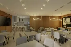 Salão de festas com mesas, cadeiras, sofás, balcão bar e luminária de LED circular — Recanto dos Corais em Abraão, Florianópolis