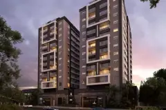 Fachada dos dois edifícios iluminados ao entardecer com céu alaranjado e entrada principal destacada — Rosa Branca em Canto, Florianópolis