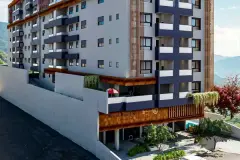 Fachada do edifício de dia com entrada em corten, jardim vertical e detalhe de bandeiras frontais — Saint Humbert II em Ingleses, Florianópolis