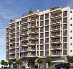 Fachada do edifício vista frontal com varandas e entrada principal com árvores na calçada — Saint Tropez Residence em Ingleses, Florianópolis