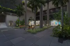 Entrada do edifício à noite com palmeiras altas, bancos, lojas iluminadas e piso de pedra — Saint Zambelli em Ingleses, Florianópolis
