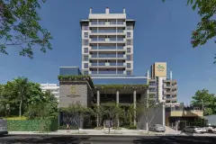 Fachada do edifício em renderização diurna, torre de 10 andares com jardim vertical e entrada principal — Saint Zambelli em Ingleses, Florianópolis