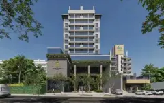 Fachada do edifício em renderização diurna, ângulo aproximado com entrada e vegetação — Saint Zambelli em Ingleses, Florianópolis