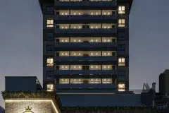 Torre do edifício à noite com varandas iluminadas e logotipo em coroa dourada — Saint Zambelli em Ingleses, Florianópolis