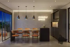 Área de convivência Friendly Space com mesa alta, bancos de madeira e letreiro neon na parede — Seleto Carlessi em Trindade, Florianópolis