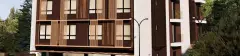 Fachada do edifício em perspectiva lateral, 8 andares com revestimento marrom chocolate e ripas de madeira nas janelas — Smart 1 Trindade em Trindade, Florianópolis