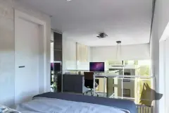 Quarto com cama de casal, mesa de trabalho com computador e abertura para home office com varanda — Solis em Ingleses, Florianópolis