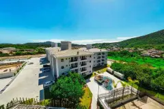 Vista aérea do conjunto com playground, quadra de areia e entorno verde — Summer Park Residence - Fase 2 em Vargem do Bom Jesus, Florianópolis