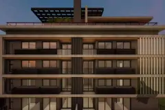 Fachada do edifício ao entardecer com 5 andares iluminados e pergola no rooftop — Sungarden Beach Home em Cachoeira do Bom Jesus, Florianópolis