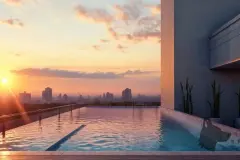 Piscina infinita no rooftop com pôr do sol alaranjado e skyline ao fundo — Tramonto em Ingleses, Florianópolis