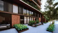Térreo do edifício com fachada de tijolinho, bancos de concreto, plantas e entrada principal — Unna Studios em Trindade, Florianópolis