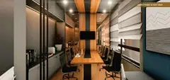 Sala de coworking e reunião com mesa de madeira, cadeiras executivas e TV — Unna Studios em Trindade, Florianópolis