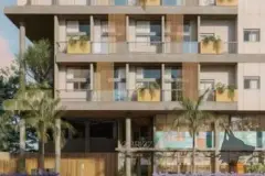 Fachada frontal de um bloco com 4 andares, ripas de madeira e jardim com palmeiras ao entardecer — Upside Beach em Ponta das Canas, Florianópolis