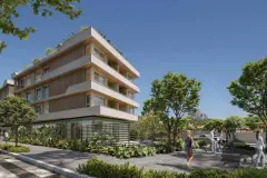 Fachada de 4 andares com jardim, calçada, pedestres e árvores ao redor à luz do dia — Upside Beach em Ponta das Canas, Florianópolis
