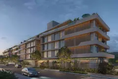 Fachada lateral iluminada à noite com varandas e jardim — Upside Beach em Ponta das Canas, Florianópolis