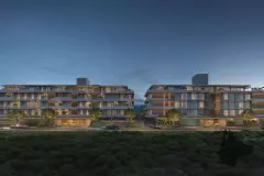 Vista frontal dos dois blocos à noite com varandas iluminadas e vegetação — Upside Beach em Ponta das Canas, Florianópolis