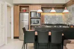 Cozinha compacta com balcão escuro, banquetas, pia e prateleiras de madeira — Upside Beach em Ponta das Canas, Florianópolis