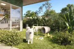 Dog park externo com cão branco, obstáculos de treinamento e jardim tropical ao redor — Upside Beach em Ponta das Canas, Florianópolis