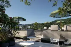 Terraço de lazer no rooftop com mesas e cadeiras brancas, guarda-sóis verdes e vista para as montanhas do Campeche — Verset em Campeche, Florianópolis