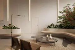 Hall de circulação com banco curvo branco, vasos de flores coloridas, mesa redonda de vidro e iluminação de fita no teto — Verset em Campeche, Florianópolis