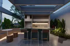 Espaço gourmet externo noturno com bancada de pedra verde-esmeralda, bancos altos, adega embutida e vegetação tropical — Verset em Campeche, Florianópolis