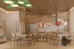 Salão infantil com luminárias em círculos verdes, mesas brancas, balões e marcenaria em madeira — Villa Maggiore em João Paulo, Florianópolis